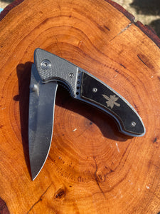 Folding knife with black micarta